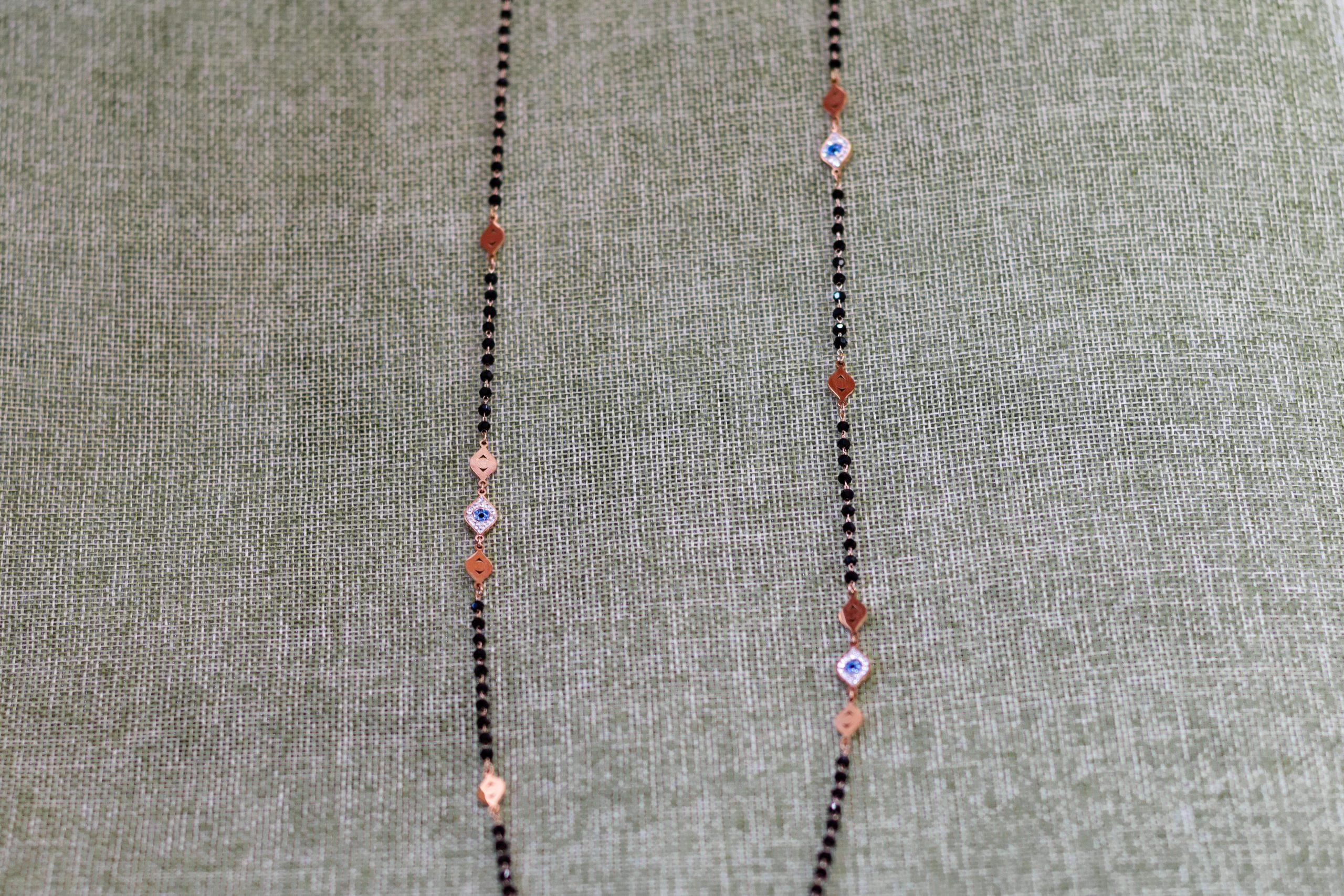 collar largo en acero rosado con ojo turco en circonitas